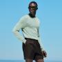 This green crewneck sweater is tailored in a slim fit and features a heavy weight, ribbed hem and cuffs, and a soft texture.