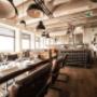 Interior of Floor17 restaurant in Amsterdam, featuring a modern dining space with warm lighting, open kitchen, and seating for lunch, dinner, and events on the rooftop terrace.